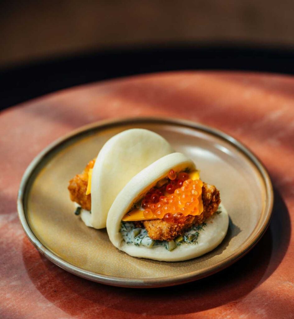 Steamed bao bun topped with salmon roe.