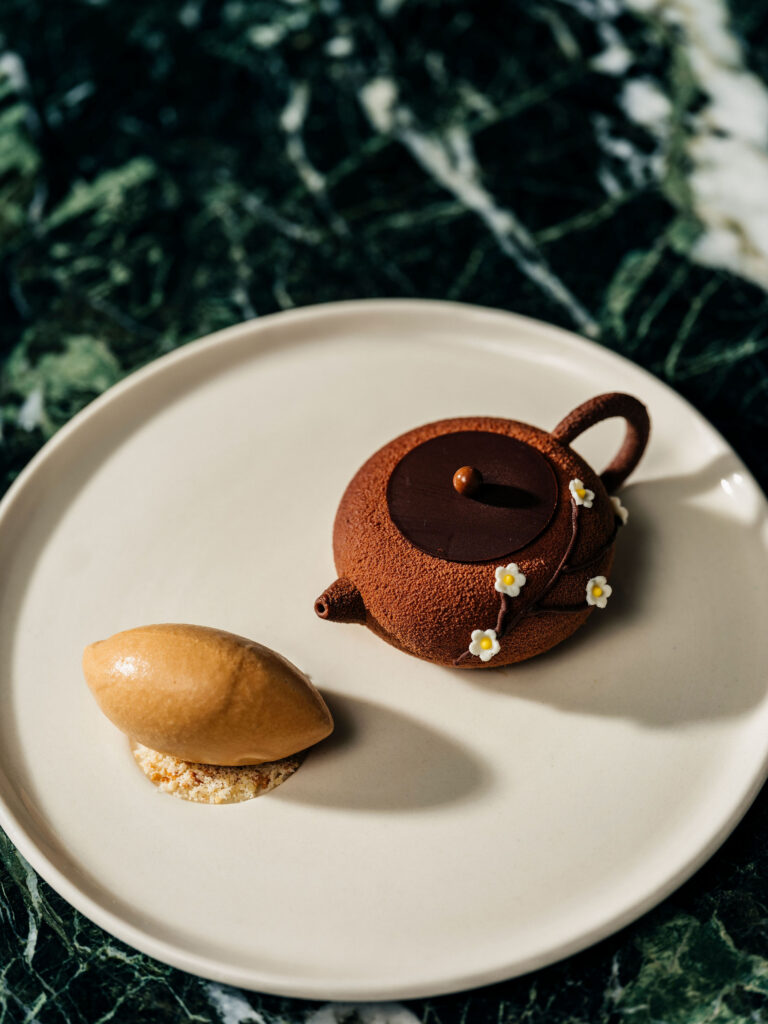 A dessert shaped like a teapot, filled with coffee mousse.